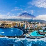 Aerial view with Puerto de la Cruz, in background Teide volcano, Tenerife island, Spain